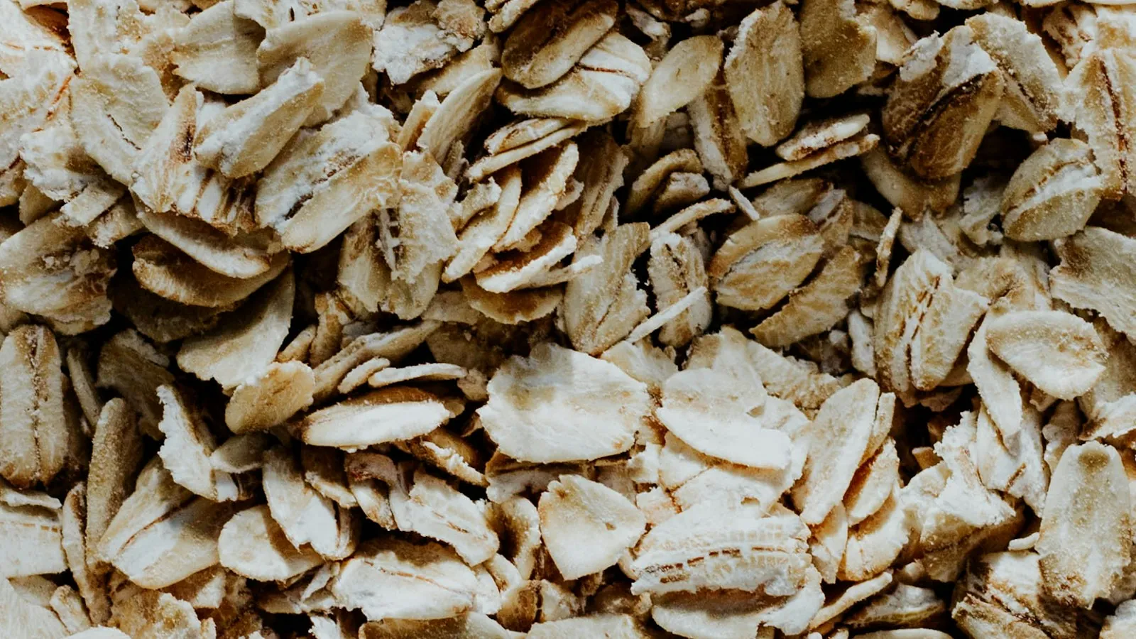 A glass bowl filled with rolled oats on a table