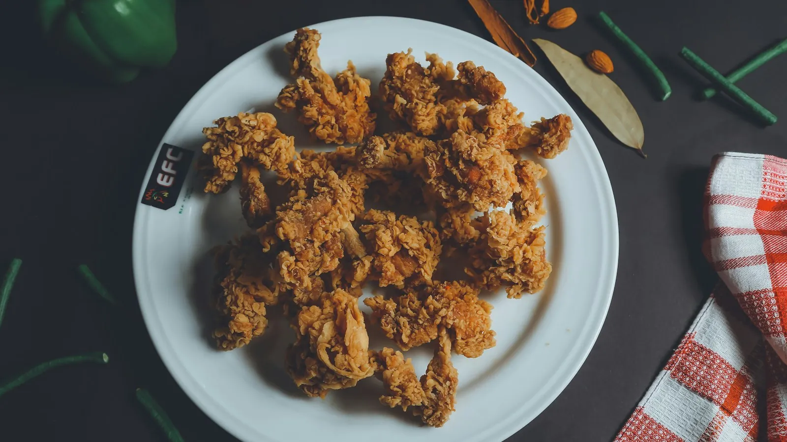 Plate of golden breaded fried chicken pieces with a crisp crust