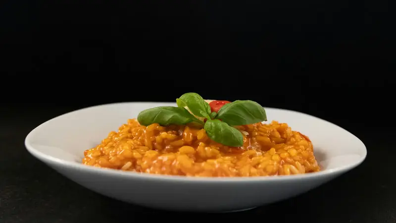 White plate of macaroni coated in a smooth, glossy cheese sauce