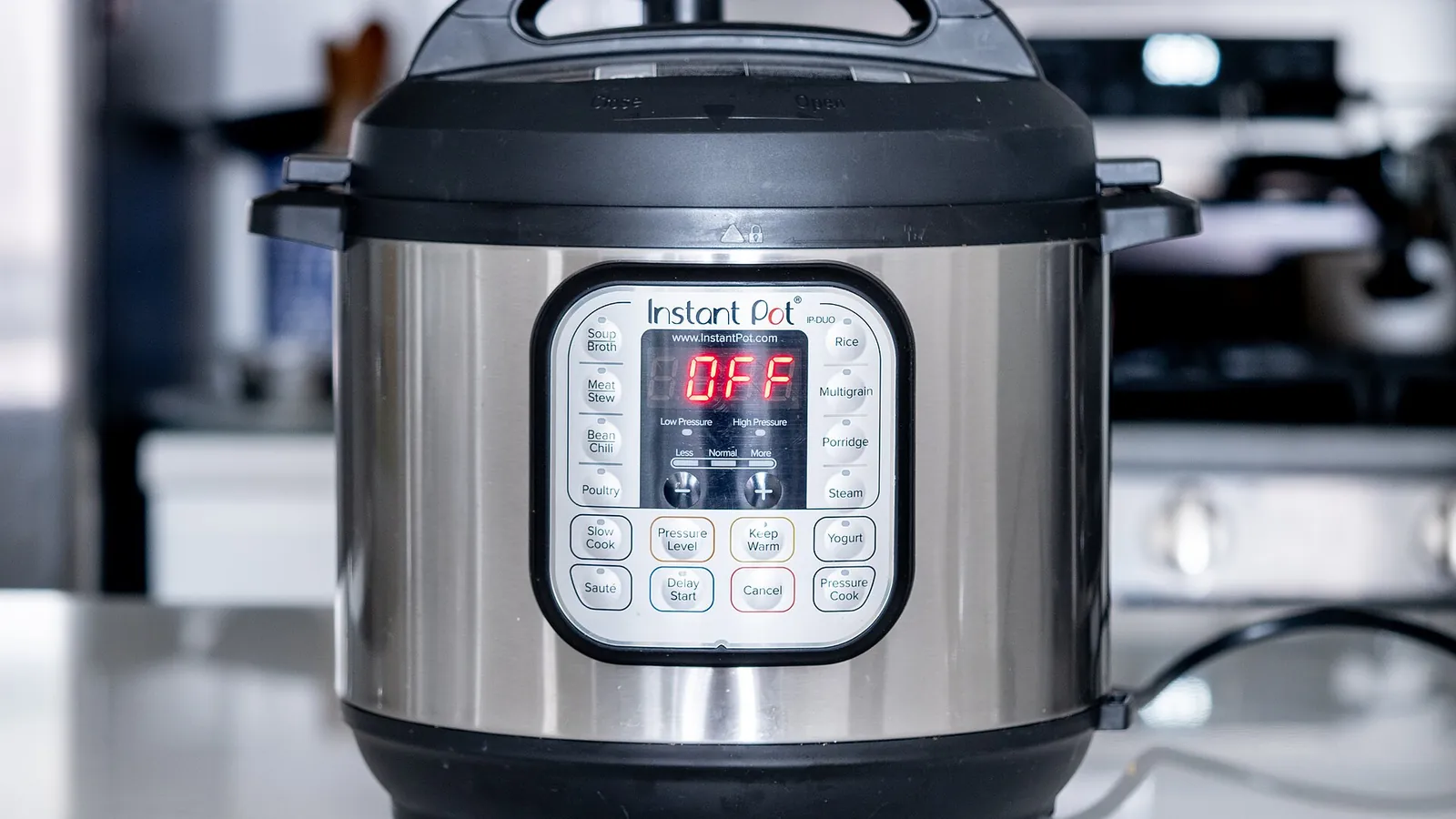 An Instant Pot electric pressure cooker with its lid on and control panel facing front