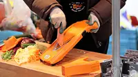 A V-blade mandoline slicer for vegetables and fruit, shown with its slicing deck