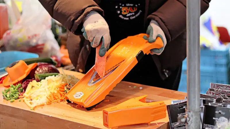A V-blade mandoline slicer for vegetables and fruit, shown with its slicing deck