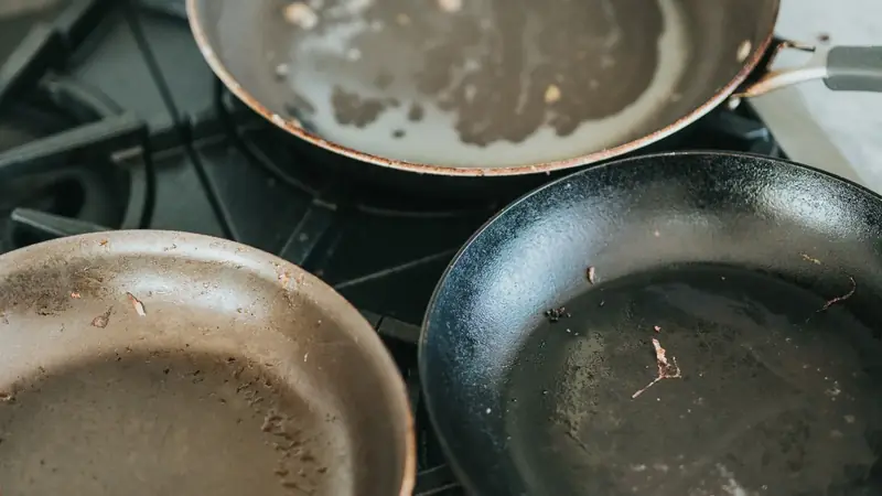 Black nonstick frying pan sitting on a stovetop burner