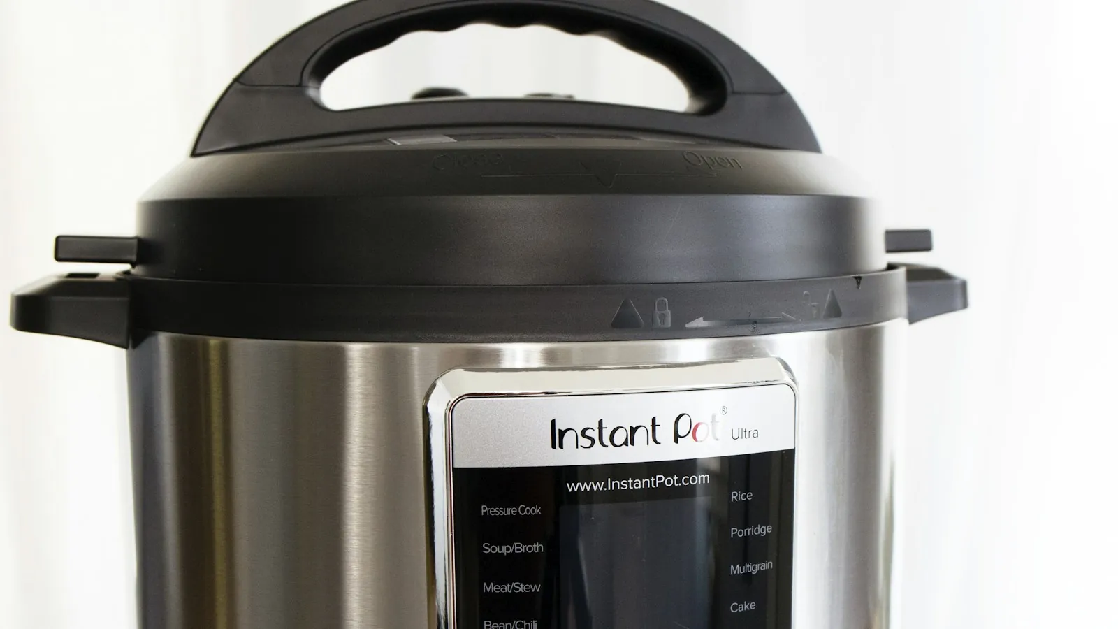 Gray and black electric rice cooker sitting on a kitchen counter