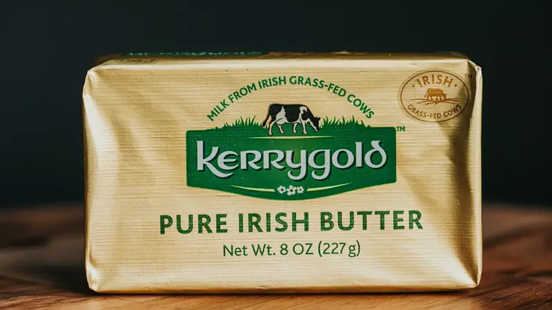 A block of butter resting on a wooden table