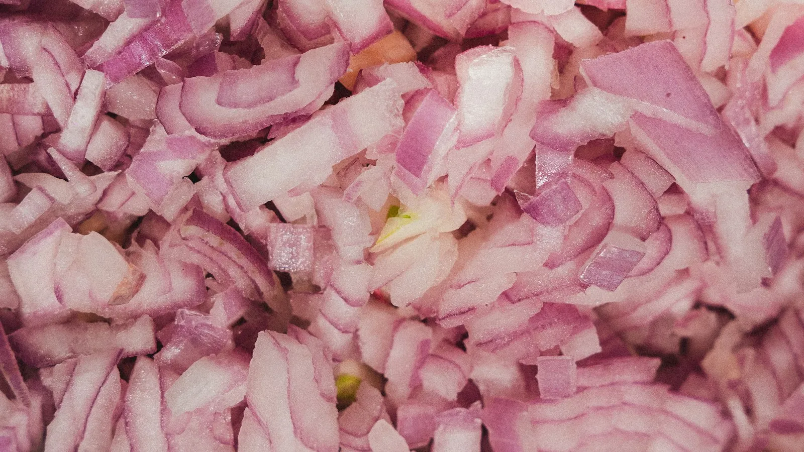 Finely diced red onion pieces ready for cooking